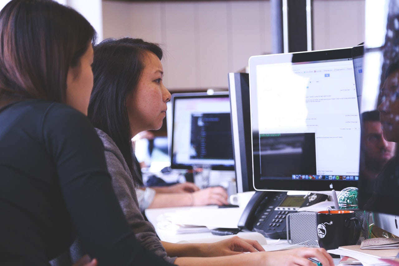 Two people looking at a computer
